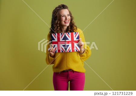 happy trendy woman isolated on green background 121731229