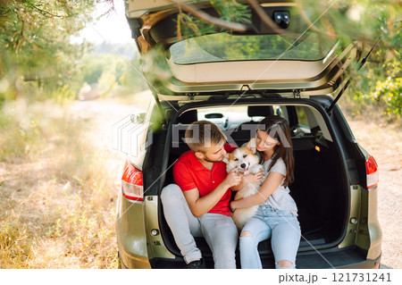 Portrait of caring, loving couple with their dog in back seat of car while traveling. Pet and human. Portrait of caring, loving couple with their dog in back seat of car while traveling. Pet and human. 121731241