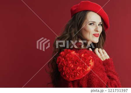 smiling modern female in red sweater and beret with red heart 121731397