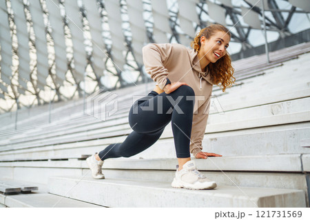 Young woman in sportswear is training outdoors. Sports concept, healthy body. 121731569