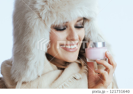 happy stylish woman in winter coat and fur hat on white 121731640