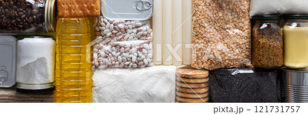 Home food supplies for quarantine and isolation, including canned food, cereals, pasta, and essential staples for survival, survival during military operations, the concept of stay at home, banner 121731757