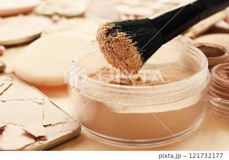 Brush with beauty cosmetics background, varieties of face powders and foundations for perfect complexion, basic make up products to even out and matte skin, selective focus, shallow DOF Brush with beauty cosmetics background, varieties of face powders and foundations for perfect complexion, basic make up products to even out and matte skin, selective focus, shallow DOF 121732177