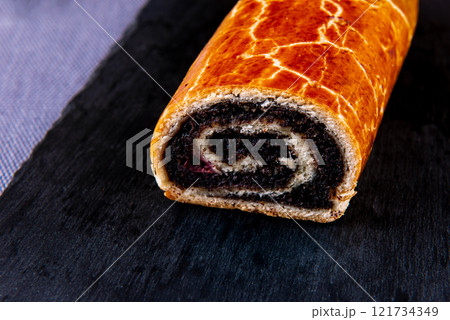 Traditional Hungarian Christmas cookies with poppy seed on a black cutting board. Traditional Hungarian Christmas cookies with poppy seed on a black cutting board. 121734349