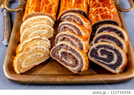 Traditional Hungarian Christmas cookies with poppy seed, walnut and almond on a copper serving tray 121734358