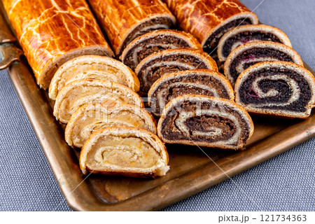 Traditional Hungarian Christmas cookies with poppy seed, walnut and almond on a copper serving tray Traditional Hungarian Christmas cookies with poppy seed, walnut and almond on a copper serving tray 121734363