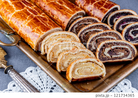 Traditional Hungarian Christmas cookies with poppy seed, walnut and almond on a copper serving tray Traditional Hungarian Christmas cookies with poppy seed, walnut and almond on a copper serving tray 121734365