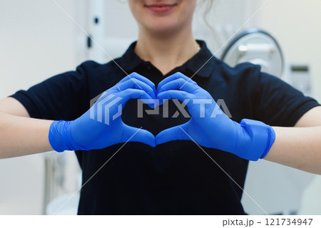 The nurse's hands in latex gloves show a heart symbol. Showing care support with love to the patient The nurse's hands in latex gloves show a heart symbol. Showing care support with love to the patient 121734947