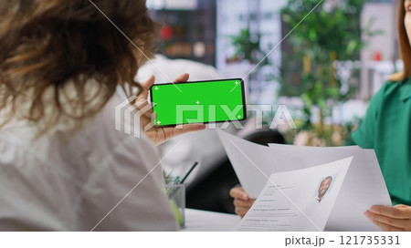 HR team selecting candidates and using a copy space mockup display in high end office, working on finding the best applicant for the job opening. Recruiters review resumes. Camera A. 121735331
