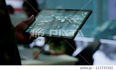 Military personnel in high tech environment safeguard classified information, monitor cybersecurity threats and digital warfare operations to protect against attacks and data breaches. Camera A. 121735382