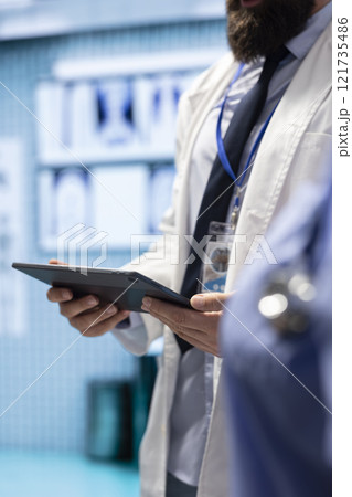 Medical experts team reviews x ray test results to find suitable treatment plan, private clinic meeting. Doctors doing teamwork for diagnostic control and analytics with radiography scans. Medical experts team reviews x ray test results to find suitable treatment plan, private clinic meeting. Doctors doing teamwork for diagnostic control and analytics with radiography scans. 121735486