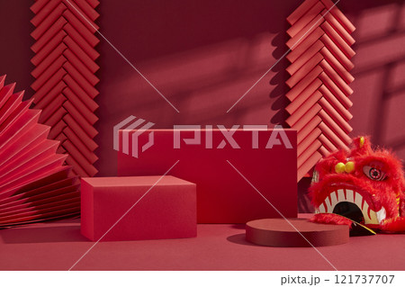 Chinese New Year promotion image. It features a red background with two strings of red firecrackers, a paper fan, three empty red platforms for product displays, and a red lion dance head. Chinese New Year promotion image. It features a red background with two strings of red firecrackers, a paper fan, three empty red platforms for product displays, and a red lion dance head. 121737707