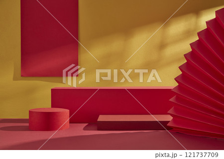On a golden background, three empty red circular and rectangular platforms for product displays are decorated with red paper strings and a paper fan. An advertisement with a Chinese New Year design. On a golden background, three empty red circular and rectangular platforms for product displays are decorated with red paper strings and a paper fan. An advertisement with a Chinese New Year design. 121737709
