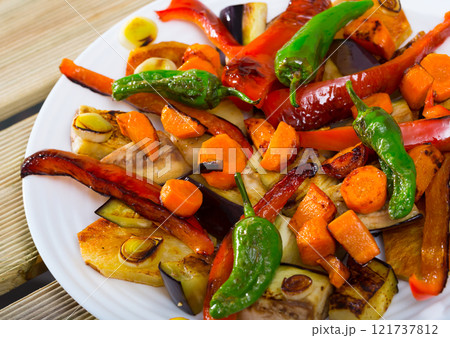 Made of tasty baked different vegetables, vegetarian food at plate 121737812