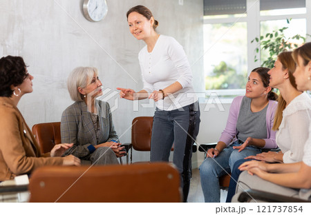 Women lead discussion sitting on chairs in circle Women lead discussion sitting on chairs in circle 121737854
