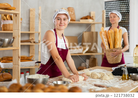 Women bakers making bread in a bakery Women bakers making bread in a bakery 121738032