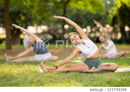 Young woman doing stretching in park 121738168