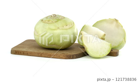 Fresh Kohlrabi Whole and Sliced on a Wooden Cutting Board Fresh Kohlrabi Whole and Sliced on a Wooden Cutting Board 121738836