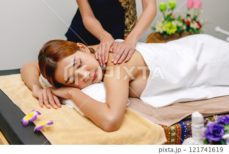 woman is getting a massage on a massage table 121741619