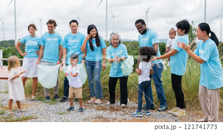 group of people wearing blue shirts are standing together, some holding bags group of people wearing blue shirts are standing together, some holding bags 121741773