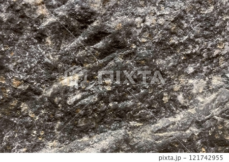 Close-Up of Rough Granite Surface.A detailed close-up image of a rough granite surface, showcasing its coarse texture and natural mineral patterns. Ideal for geology and natural texture references. 121742955