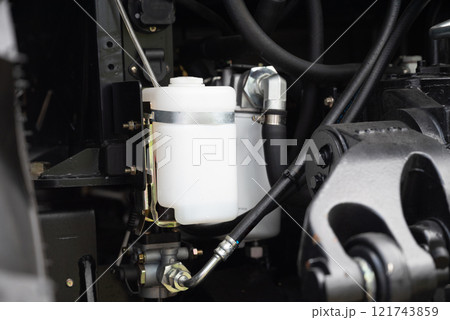 Close-up of a complex automotive engine system with white filters. 121743859