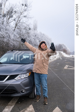 Man Taking Selfie with SUV on Snowy Roadside Man Taking Selfie with SUV on Snowy Roadside 121744004