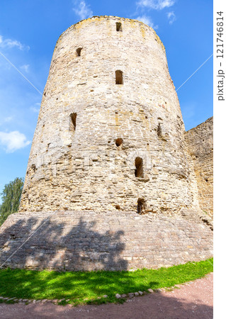 Stone tower of the ancient Izborsk fortress against a blue sky. Izborsk, Pskov region, Russia. Medieval castle on the 14th century Stone tower of the ancient Izborsk fortress against a blue sky. Izborsk, Pskov region, Russia. Medieval castle on the 14th century 121746814