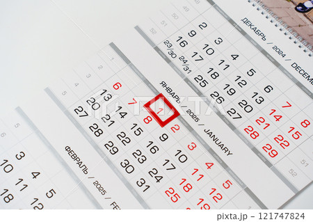 Sheets of a tear-off calendar for 2025 with a red frame.  121747824
