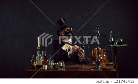 Plague doctor, blending mystery and history, surrounded by glowing flasks and aged glass bottles in dimly lit workspace. 121748412