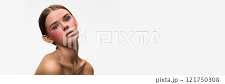 Banner. Confident woman with bold, make up highlights her featured against white studio background with negative space to insert text. Concept of natural beauty. 121750308
