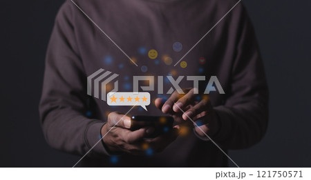 Young Man hand holding Smart Phone with five star to review and give 5 stars with very good Young Man hand holding Smart Phone with five star to review and give 5 stars with very good 121750571