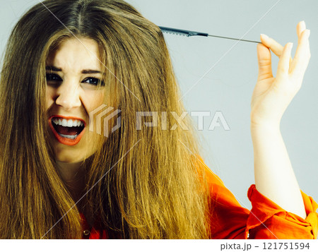 Woman having tangled hair 121751594
