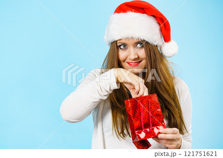 Christmas woman puts her hand into gift bag Christmas woman puts her hand into gift bag 121751621