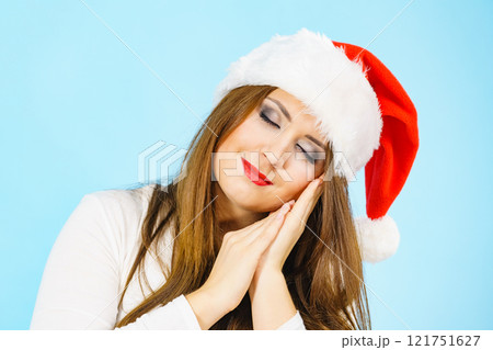 Woman in santa hat being sleepy 121751627