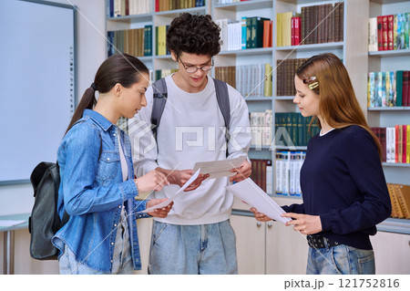 Group of college students teenage girls and guy talking inside library classroom 121752816
