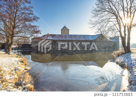 Svihov castle surrounded by a moat in winter, medieval landmark in Region Pilsen in Czech Republic, Europe. 121753883