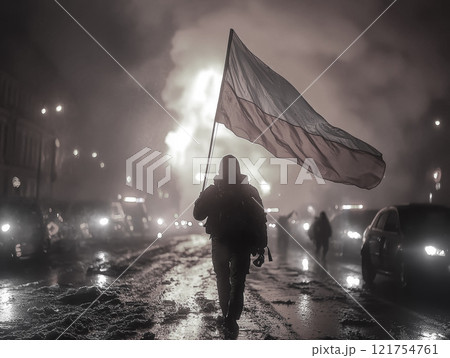 Mysterious figure standing defiantly against a line of riot police, holding a flag high, smoke-filled air 121754761