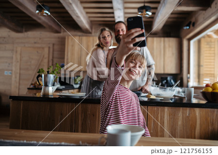 Girl is sitting at the table videocalling with grandparents. Morning routine for family. Girl is sitting at the table videocalling with grandparents. Morning routine for family. 121756155