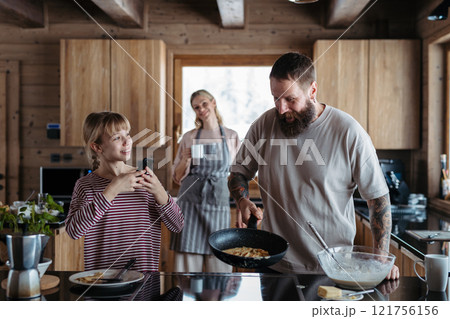 Family making pancakes, preparing sweet breakfast in the morning. 121756156