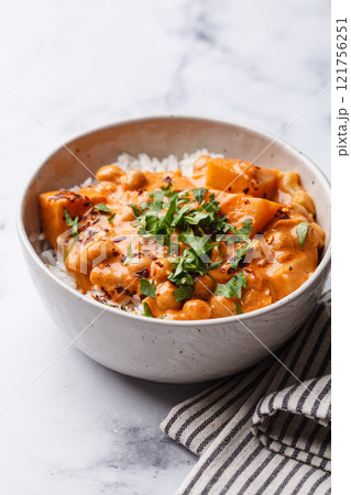 Vegan curry chickpea stew with vegetables in white bowl. Vegan curry chickpea stew with vegetables in white bowl. 121756251