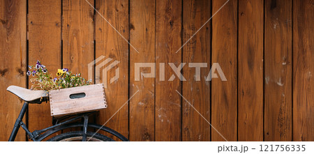 Vintage bicycle with upcycled wooden crate and potted plants against rustic wooden wall, emphasizing sustainable living and creative gardening solutions. Sustainable Lifestyle and Upcycling 121756335