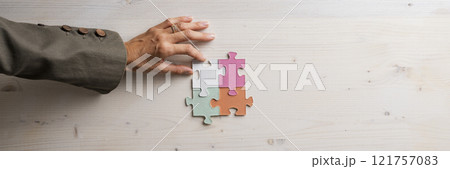 Problem solving conceptual image with a hand completing a puzzle 121757083