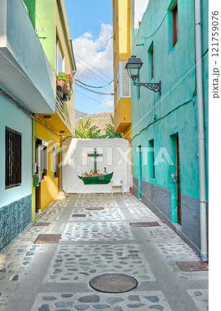 Colorful old buildings with a wall with a cross or crucifix in the city of Santa Cruz de La Palma. Bright and vibrant homes or houses built by traditional architecture in the morning in a village 121759076