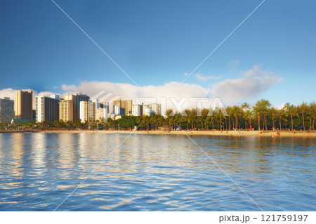 Beautiful landscape of a city near the beach and blue sky for a holiday or vacation destination. Cityscape surrounded by nature, trees, the sea, and the ocean. Scenic view of the urban scene by water 121759197