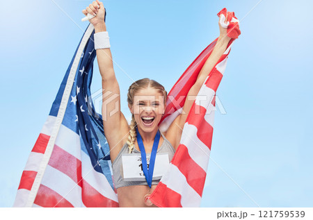 Female american winning athlete cheering and raising USA national flag after competing in sport. Smiling fit active sporty woman feeling motivated and excited, achieving a gold medal in Olympic sport 121759539