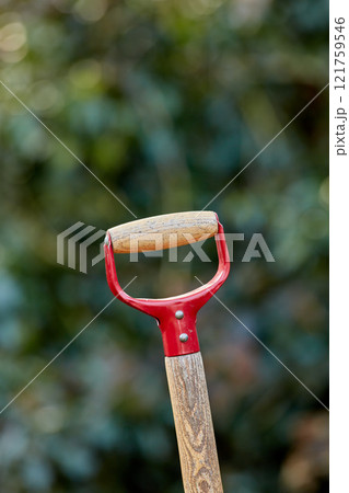Closeup of wooden shovel handle in a garden or field with copyspace. Zoom in on macro details, patterns and shape of a gardening tool ready to be used in springtime. Digging made easier with tools 121759546