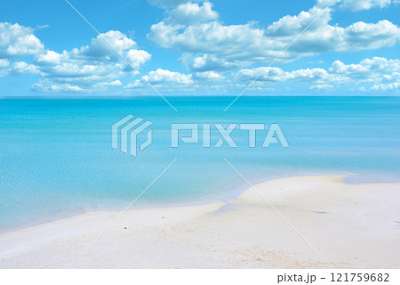 Copy space at the beach with a cloudy blue sky background above the horizon. Calm ocean water across the sea along the shore. Peaceful and tranquil landscape for a relaxing and zen summer getaway 121759682