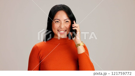 Woman, phone call and listen by studio background with smile, talk and excited on mobile network. Japanese person, girl and smartphone for chat, happy or contact with conversation, story or gossip 121759772