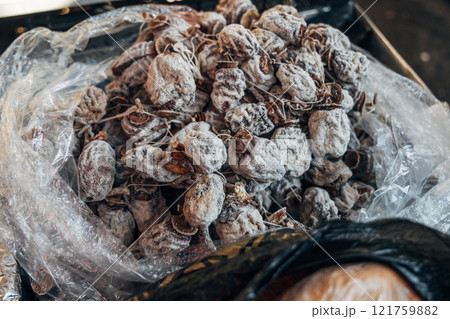 Dried persimmon fruits are sold at the market 121759882